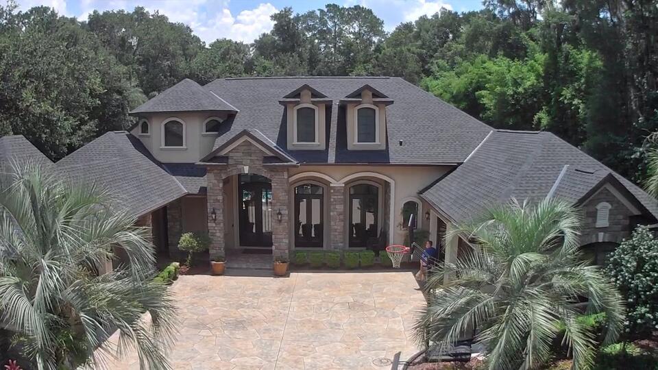 roofing gainesville-new gray roofing shingles on a home with stone siding