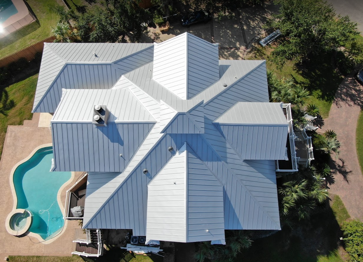 roofing milton-new white metal roofing on a home with a pool