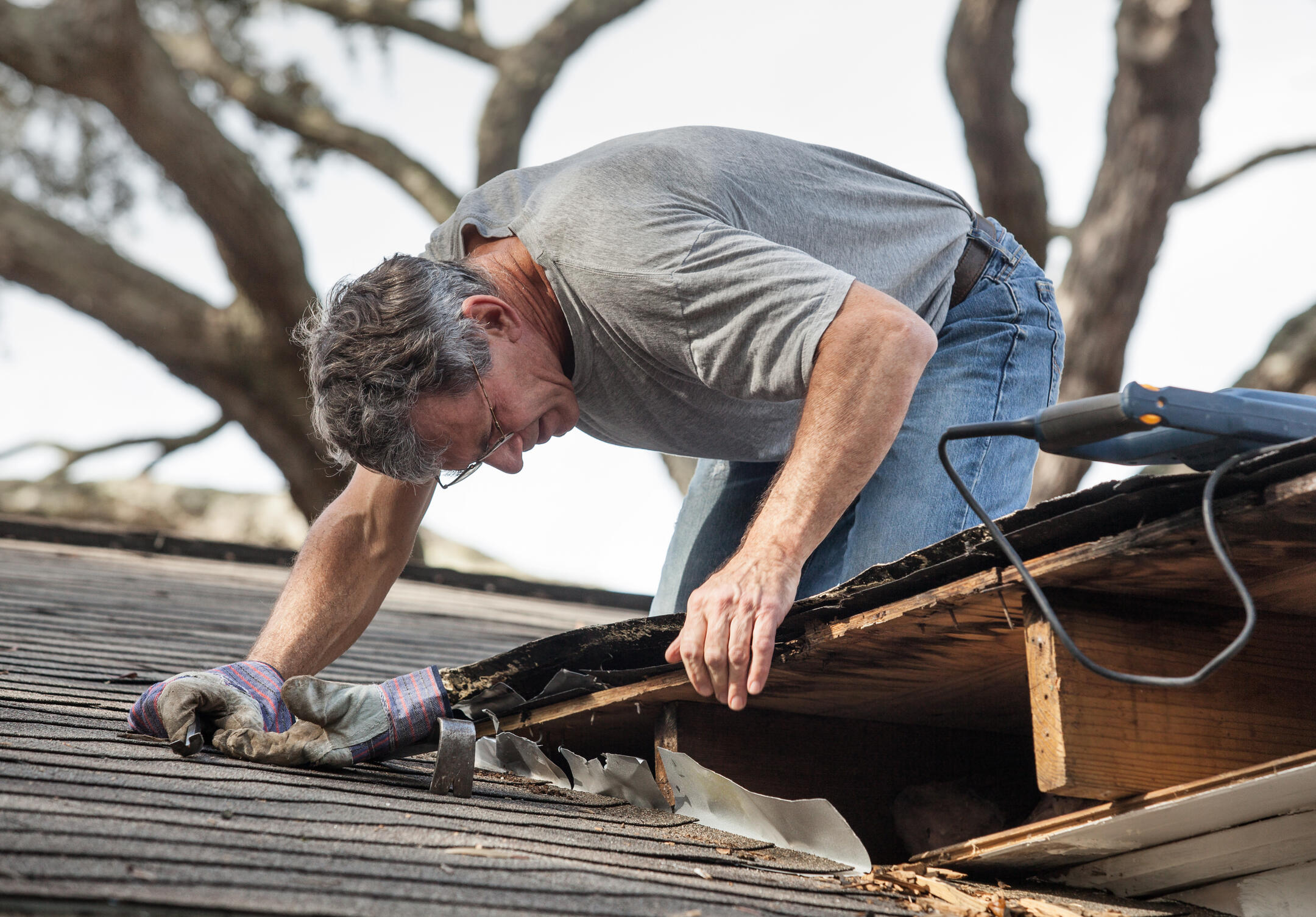 roof leak repair-man inspecting roof for leaks