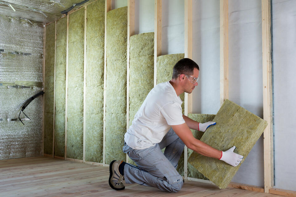 best insulation for attic-boards of insulation being installed to attic walls