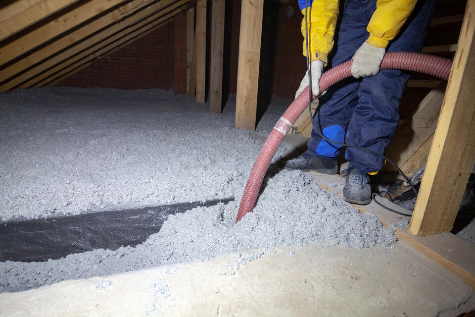 best insulation for attic-insulation being sprayed into flooring of attic