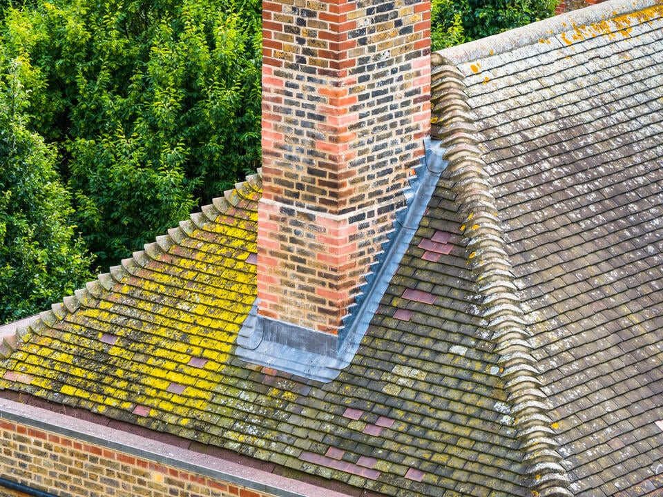 chimney flashing repair-roof that needs to be cleaned or replaced with metal chimney flashing