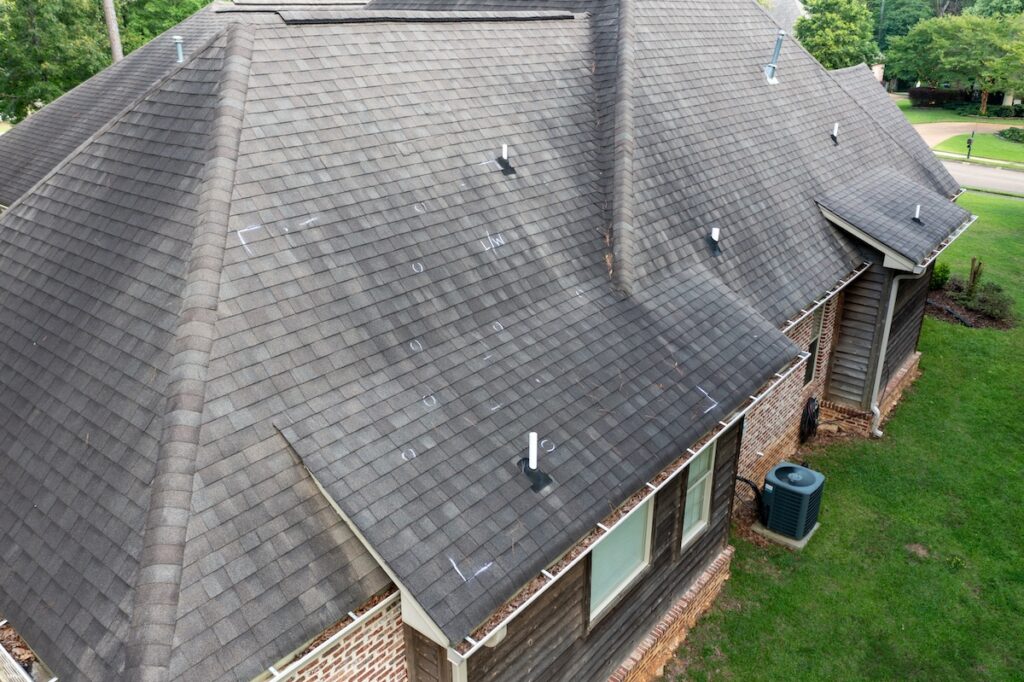 Roof with hail damage and markings from inspection