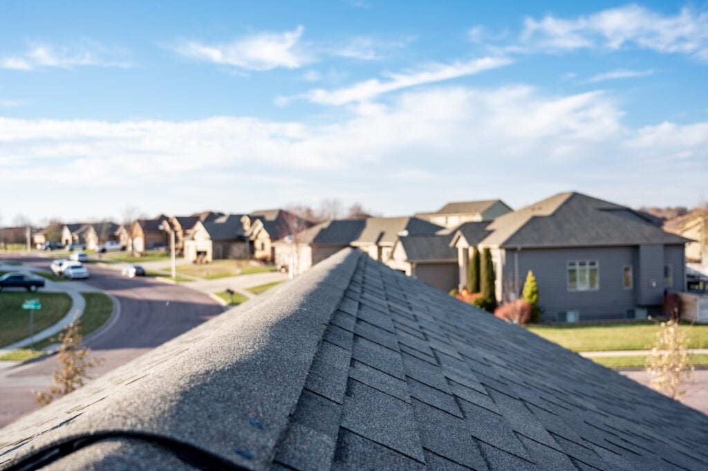Typical residential ridge cap on a shingle roof apex 
