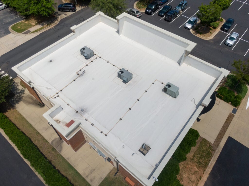 Drone Images of Commercial Roofs Featuring TPO and Asphalt Shingles: Midday, Sunny, No People flat roof replacement