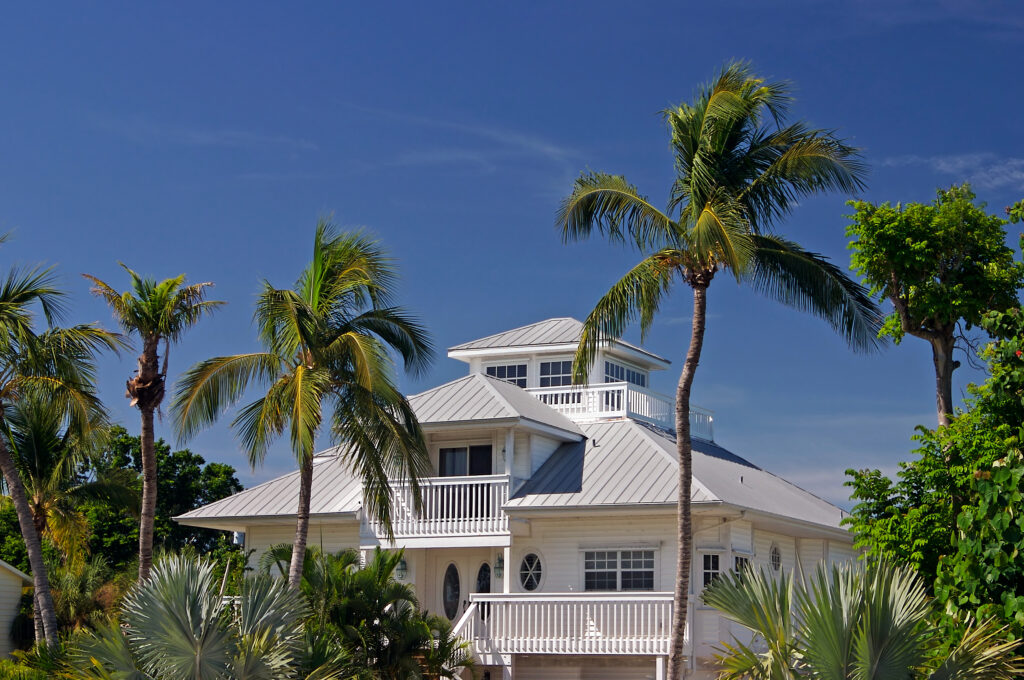 Tropical beach setting with a beautiful Florida style home metal roof