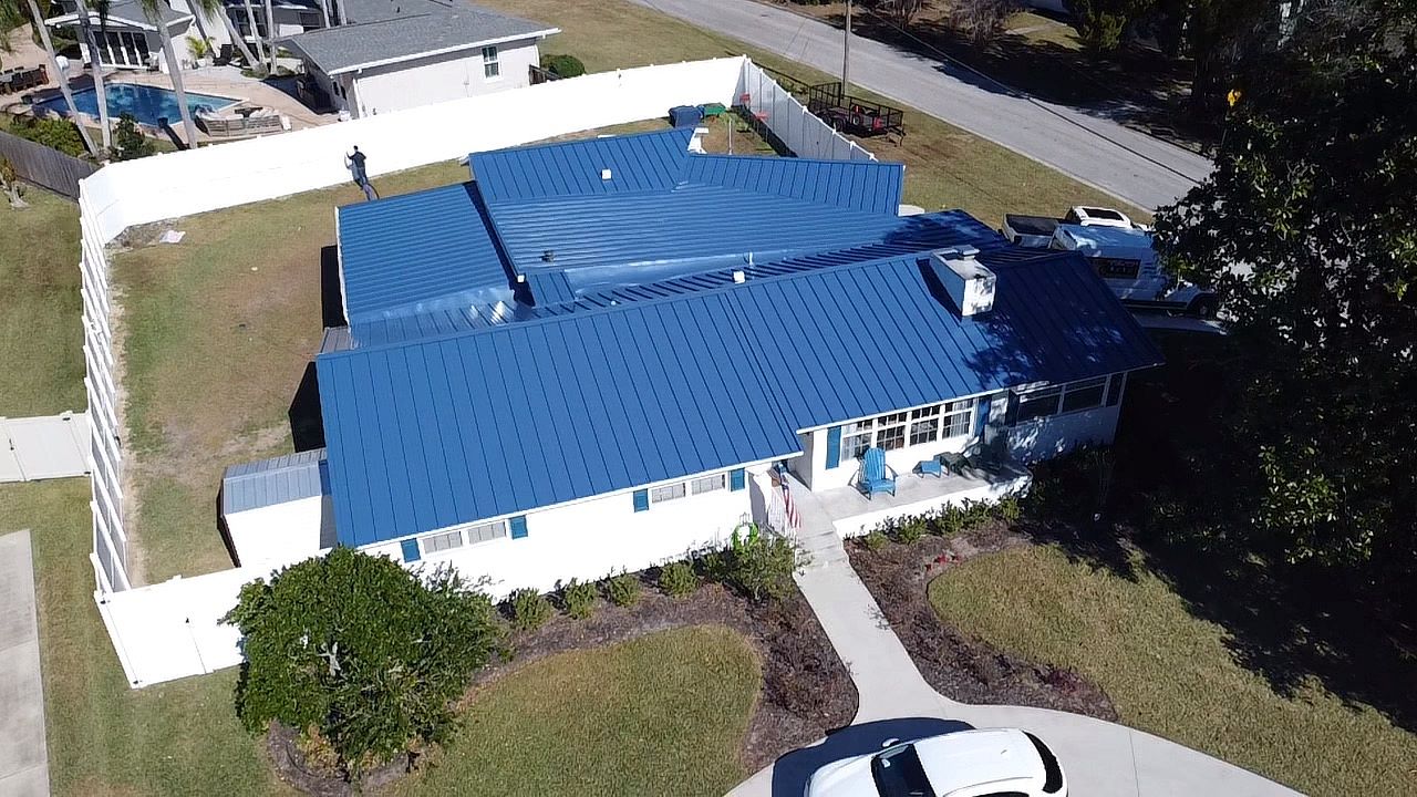 Aerial view of a blue standing seam metal roof replacement on a home in Ocala, Florida