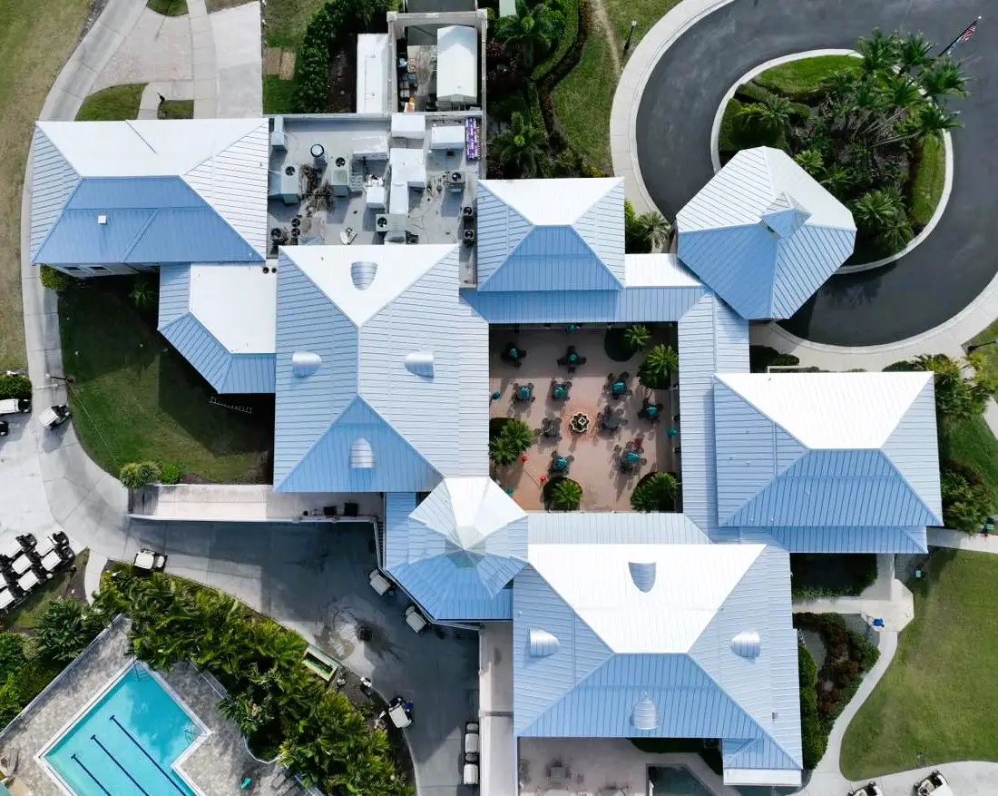Aerial view of a white standing seam metal roof on a large commercial building in Florida