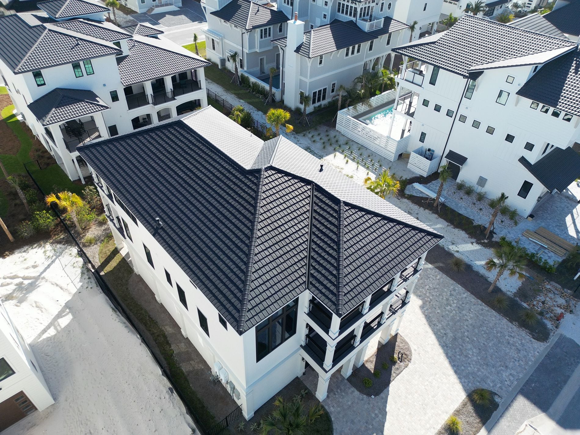 Aerial view of a black DECRA stone-coated steel roof on a luxury home in Panama City Beach, Florida