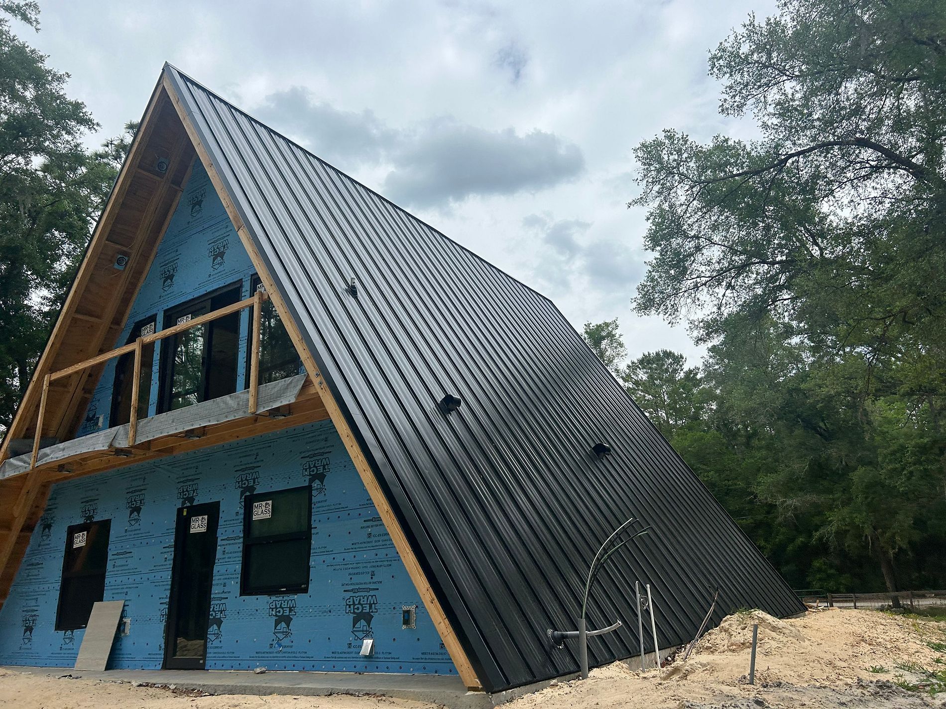 26-gauge black standing seam metal roof installed on an A-frame new construction home in Dunnellon, Florida