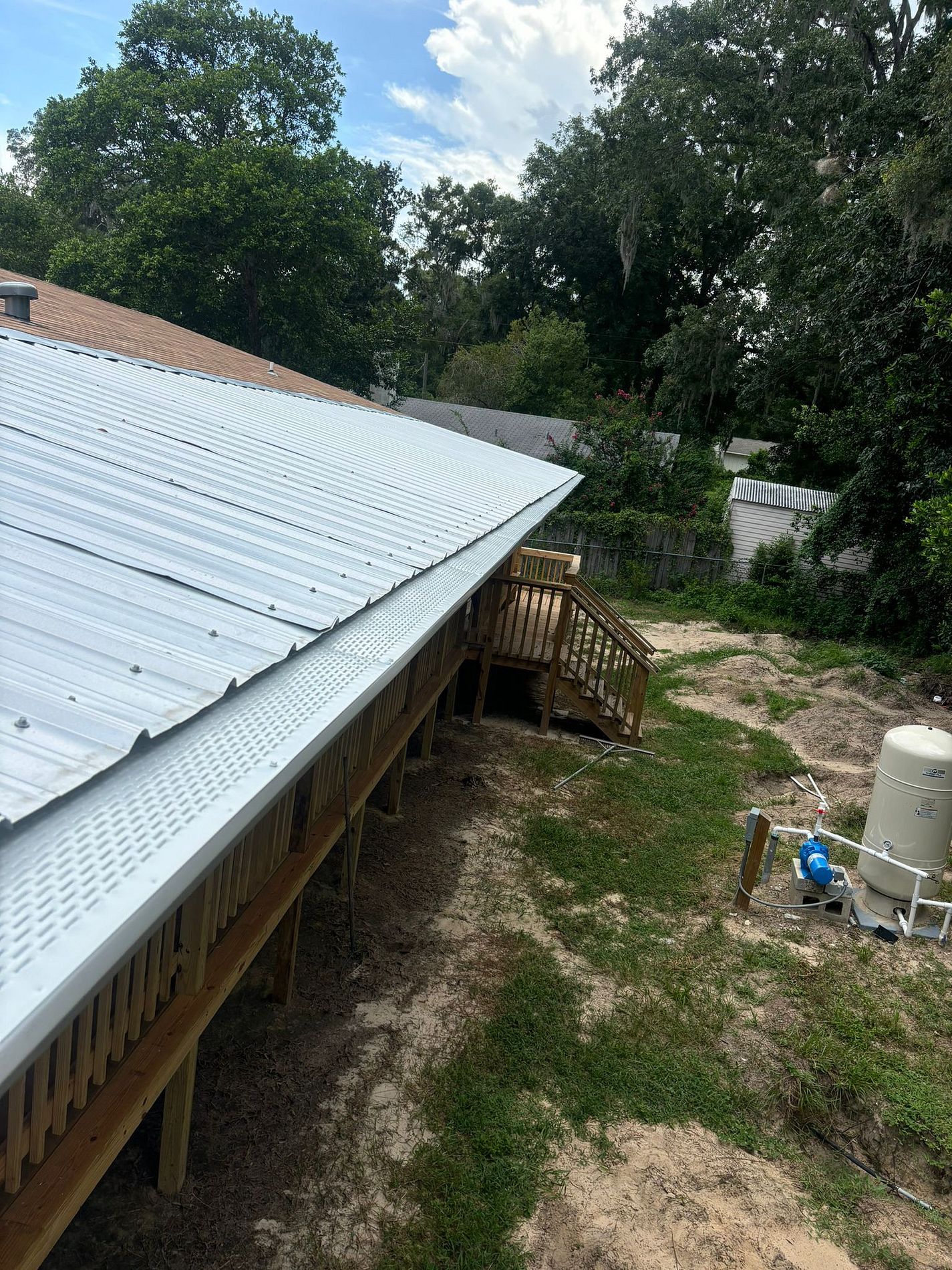 White 6-inch seamless aluminum gutters with leaf guards installed on a Florida home