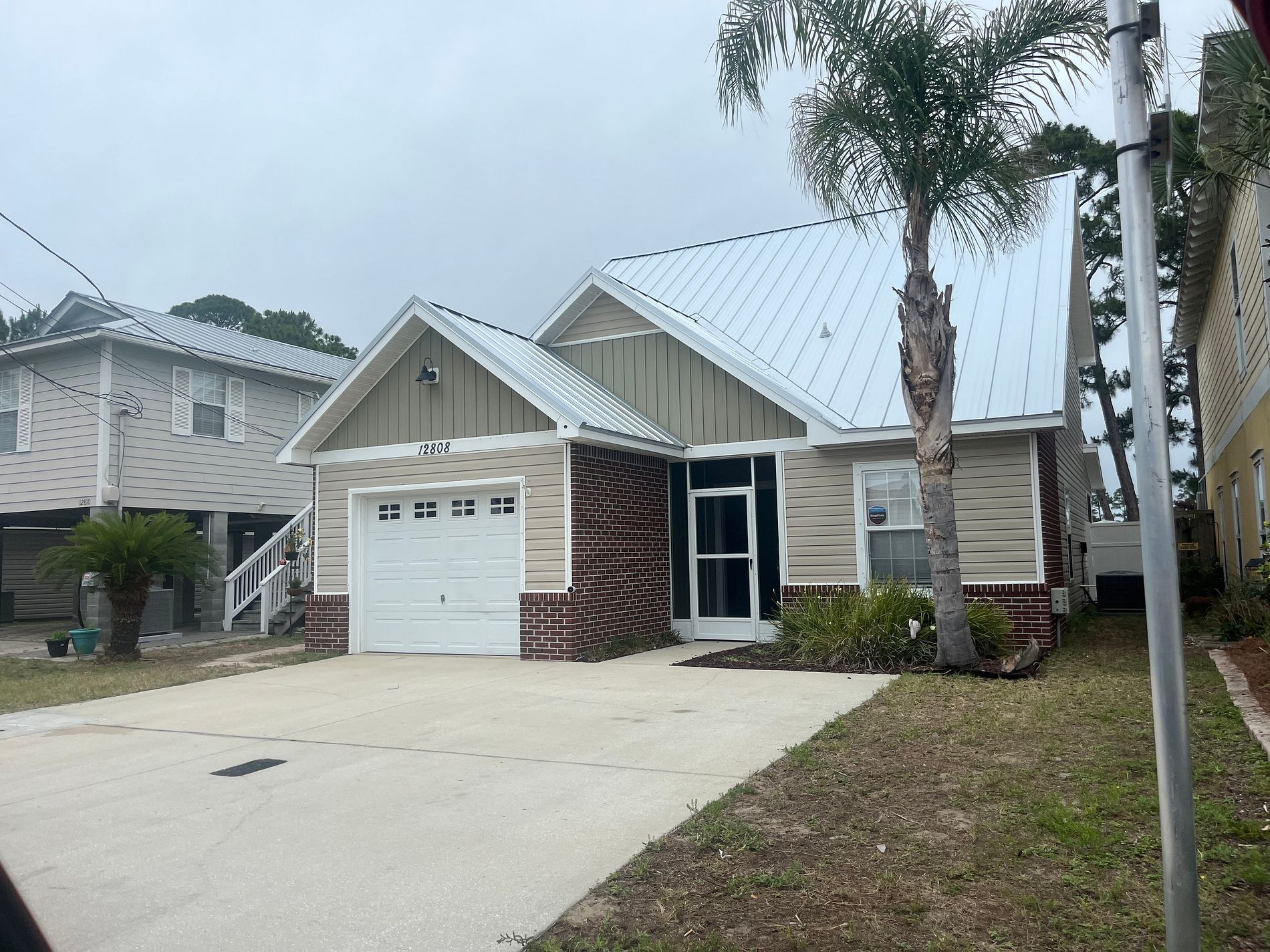 White standing seam metal roof installed on a residential home in Panama City Beach, Florida