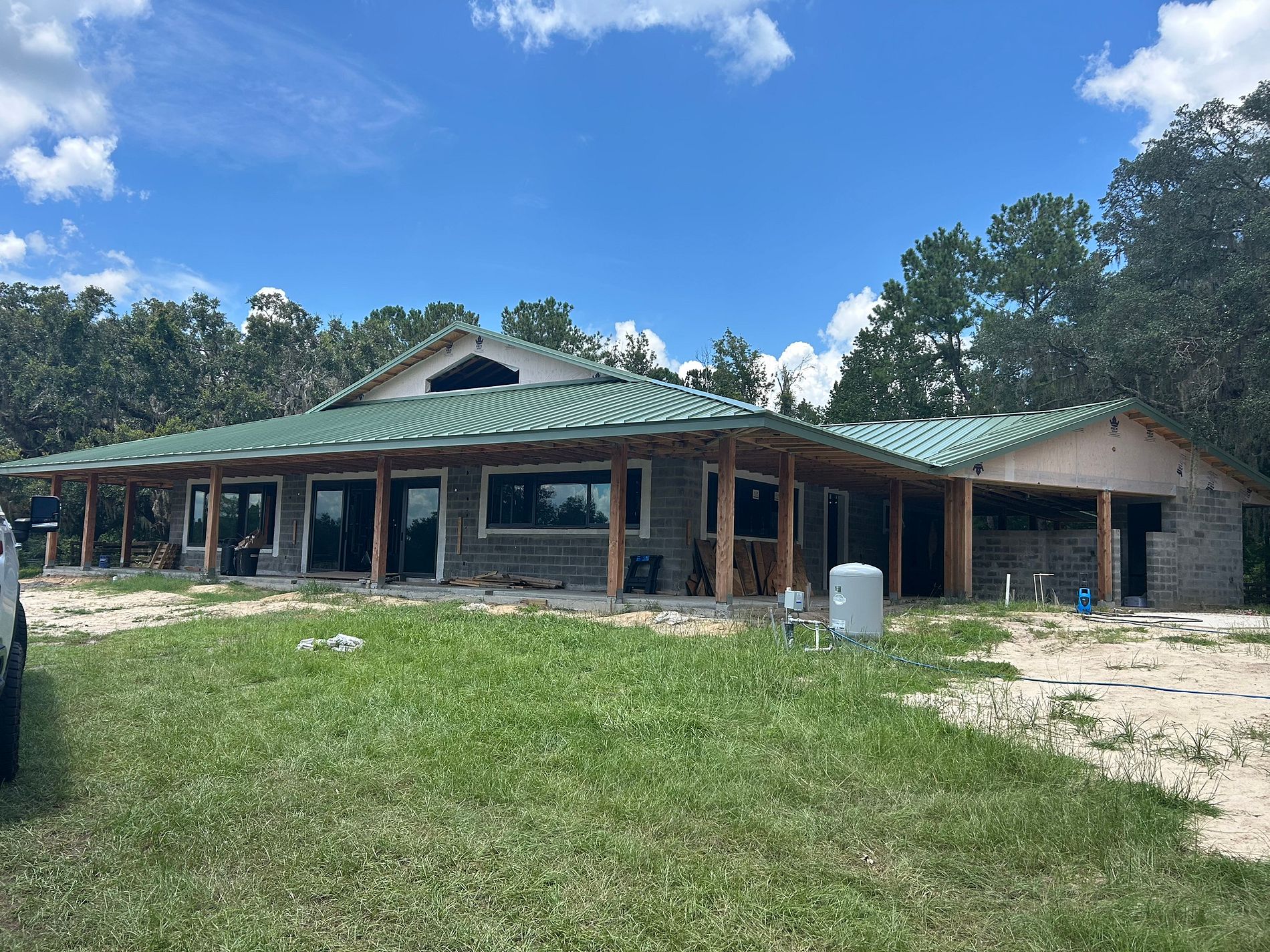 26-gauge green standing seam metal roof installed on a new construction home in Florida