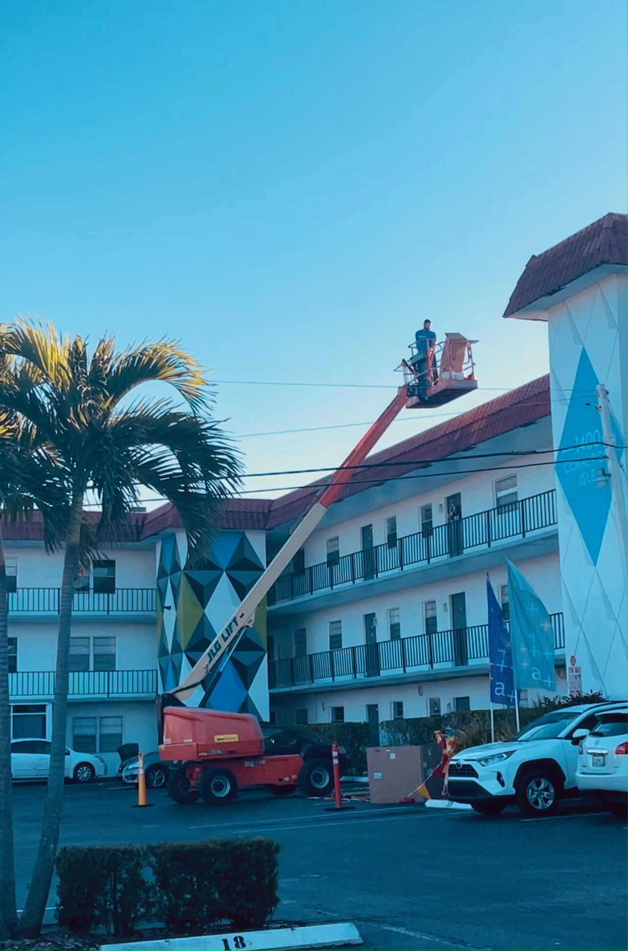 Commercial roofing crew performing preventative roof maintenance on a multi-story building in Florida