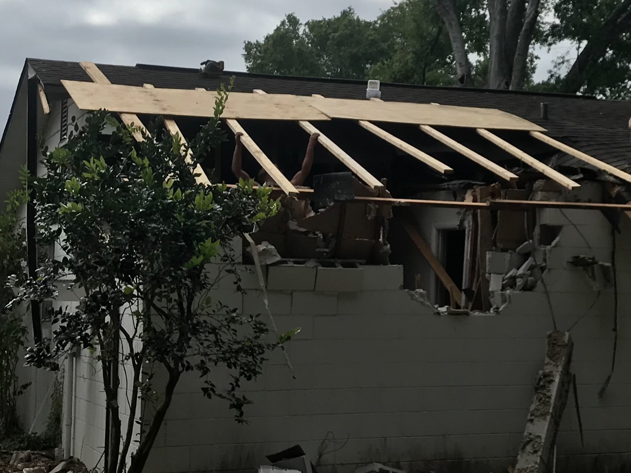 Severely damaged residential roof with exposed framing during temporary roof stabilization in Orlando, Florida