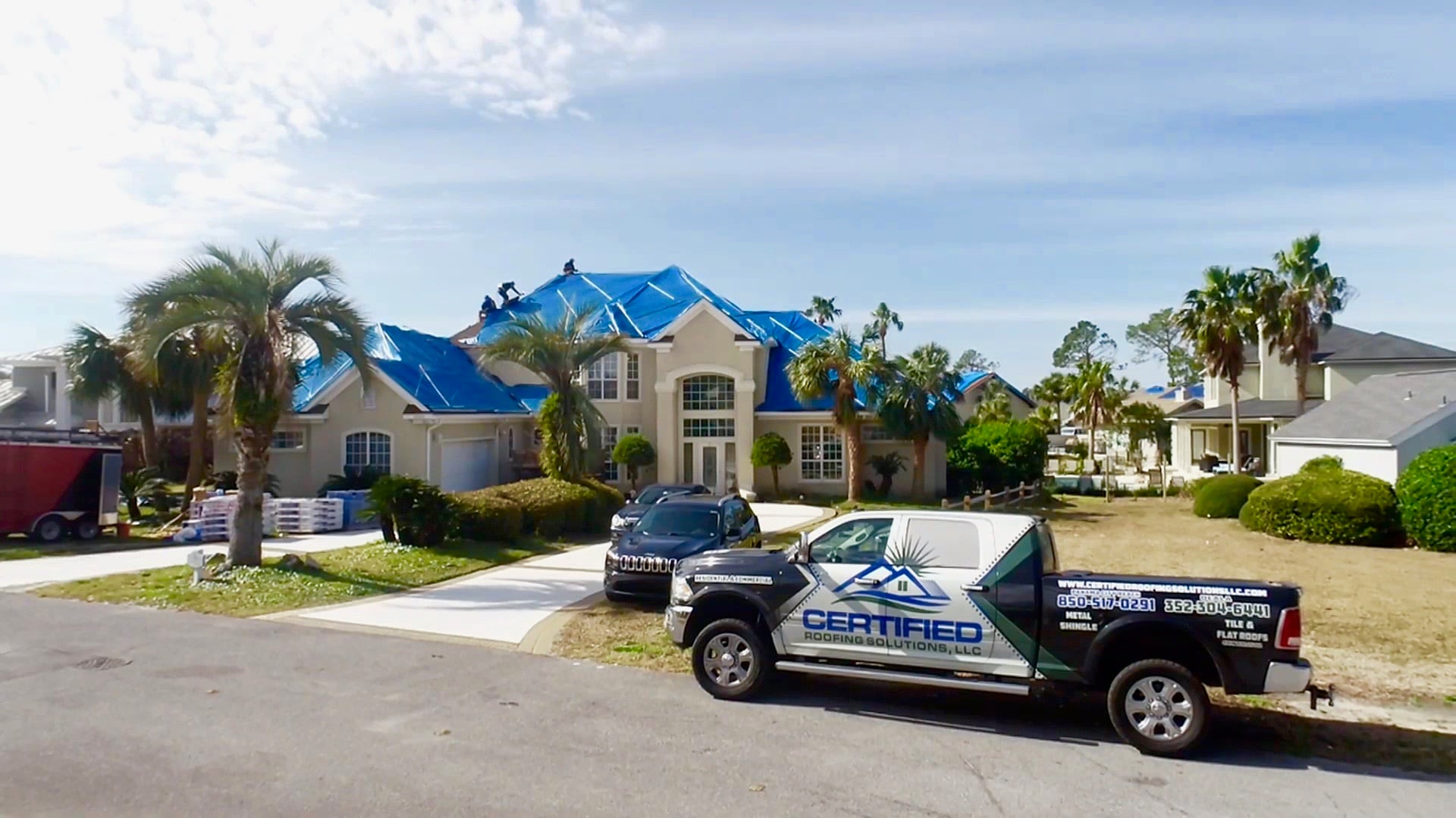 Blue emergency roof tarps installed on a storm-damaged home in Panama City Beach, Florida