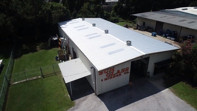 Aerial view of a commercial metal building in Ocala with a newly installed metal roof by Certified Roofing Solutions.