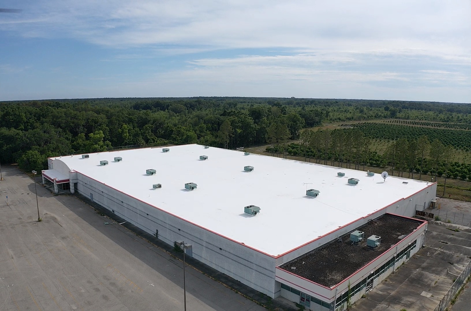 Aerial view of a white commercial flat roof coating system on a Kmart building in Ocala, Florida