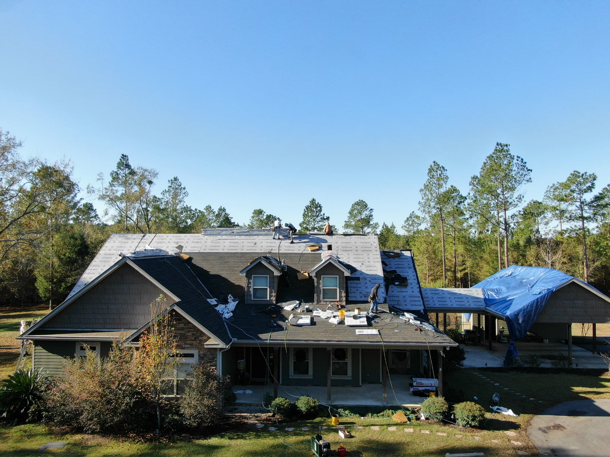 Storm-damaged residential roof undergoing emergency replacement in Chipley, Florida