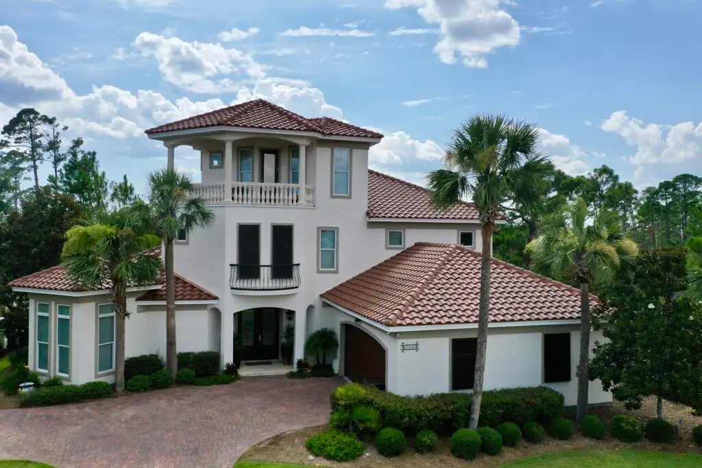 Luxury Florida home with a red Spanish tile roofing system