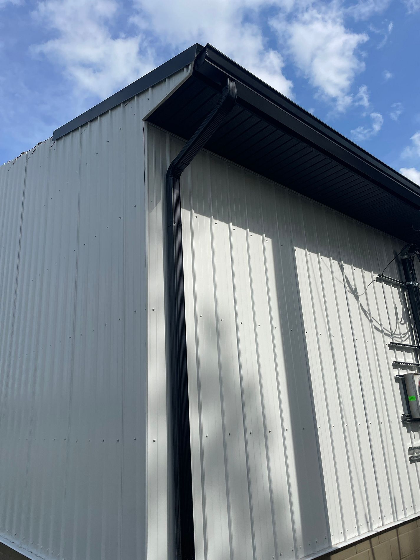 Commercial exterior renovation with new metal siding, fascia, and trim in Florida