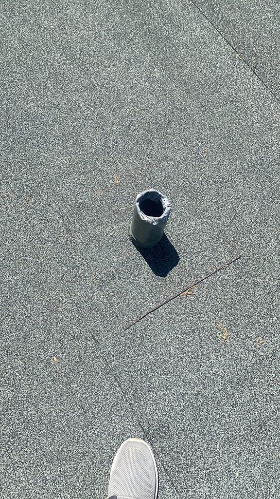 Flat roof pipe penetration after new weatherproof flashing installation