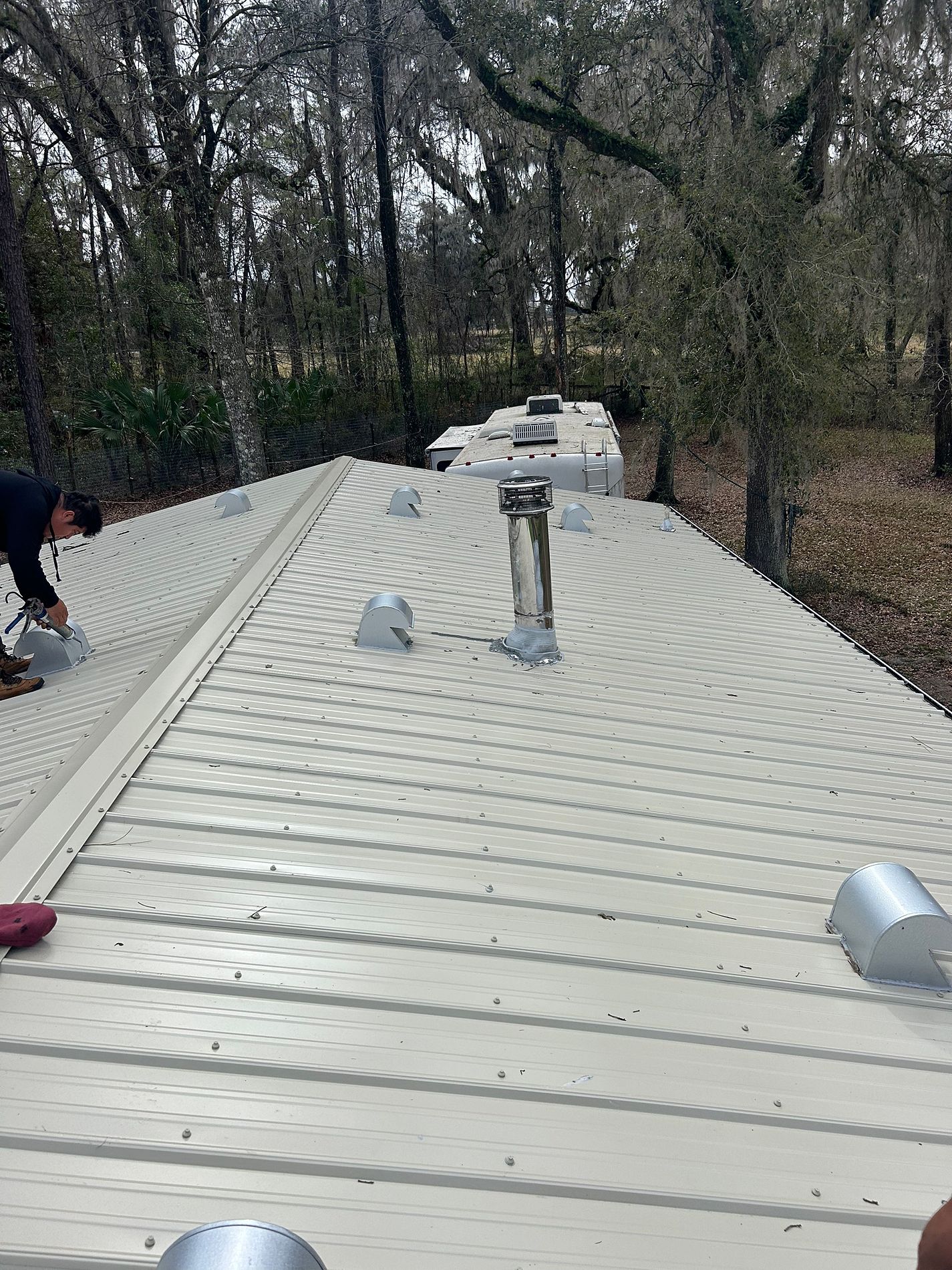 Light Stone exposed-fastener metal roof installed on a property in Perry, Florida