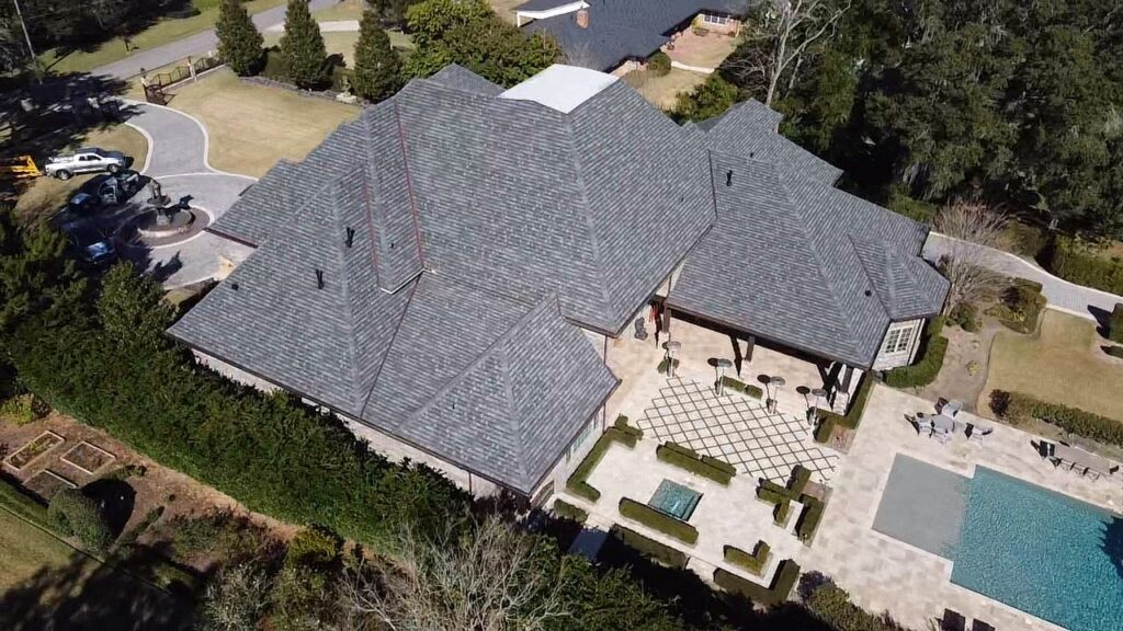 High-angle drone shot looking down at the multi-faceted GAF Slateline shingle roof and backyard patio in Ocala, FL.