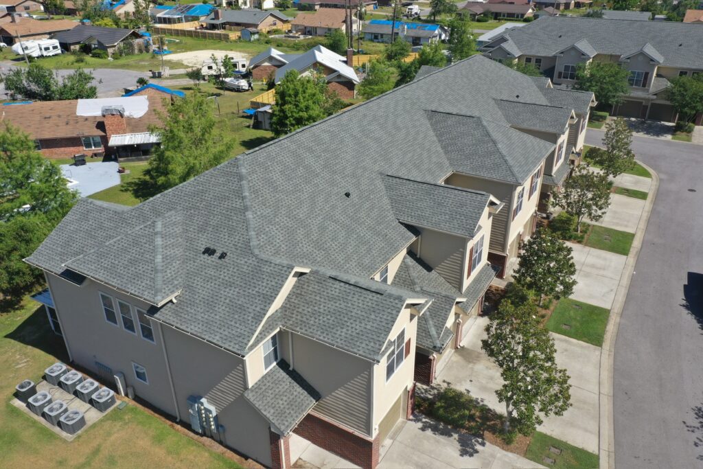 Elevated drone photo showing new GAF Timberline HDZ architectural shingles on a townhome building in Panama City Beach, FL.