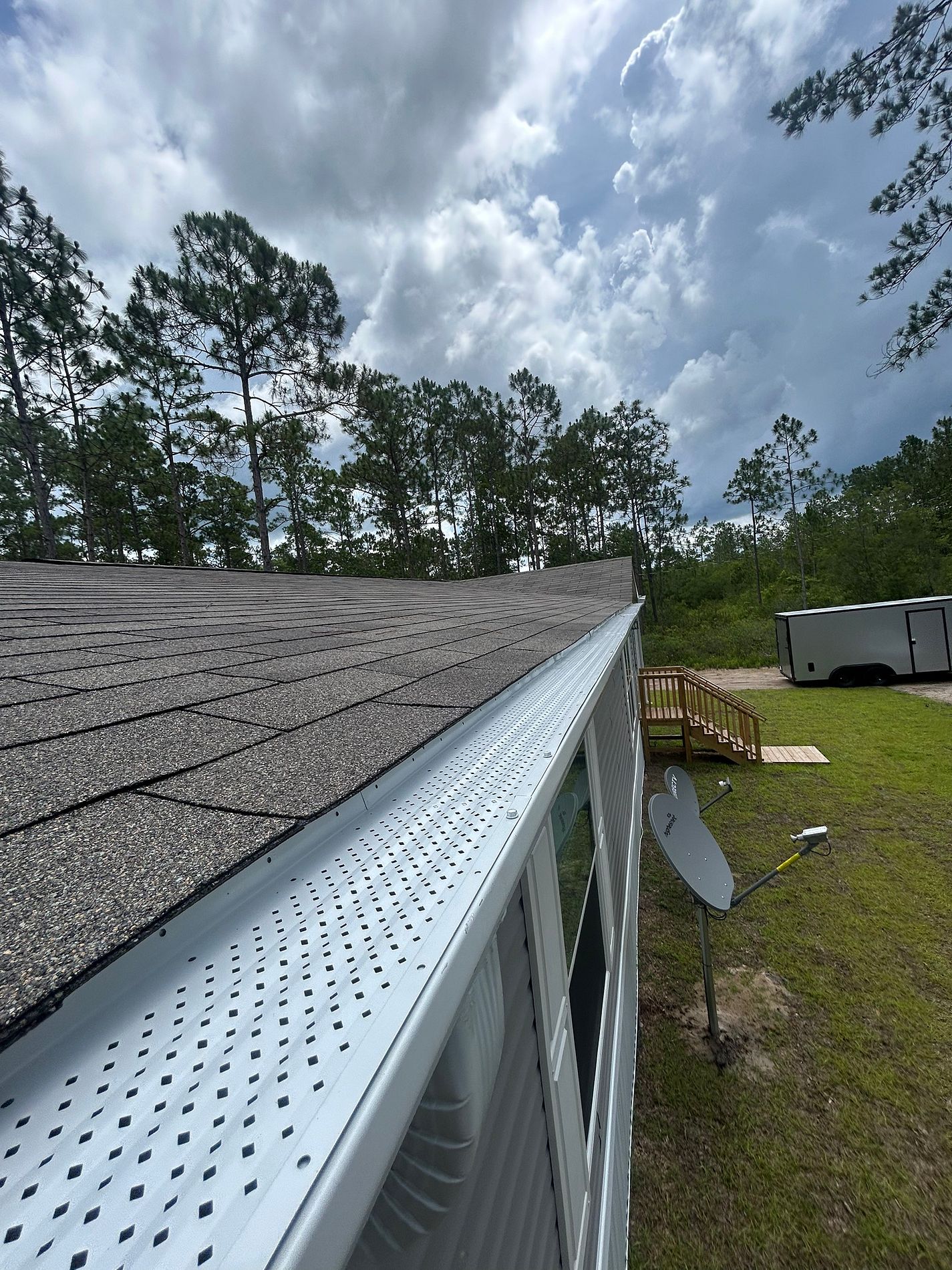 White 6-inch K-style gutter and perforated leaf guard installed on a home in Crawfordville, Florida