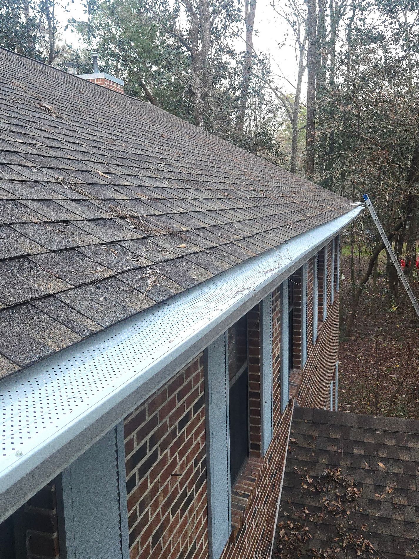 White gutter and leaf guard system installed on a brick home in Havana, Florida
