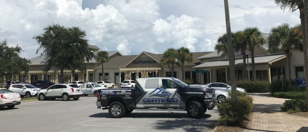 Certified Roofing Solutions branded truck parked on site for a commercial roofing project in Panama City Beach, FL.