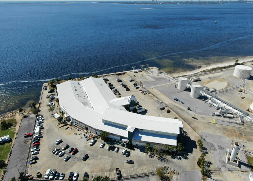 High aerial drone photo of the completed commercial reroof for Bluewater Development on the bayfront in Panama City, FL.