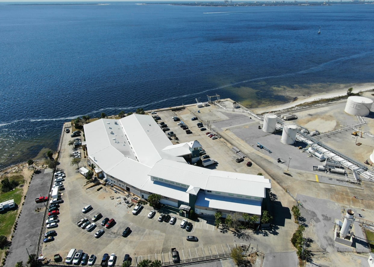 High aerial drone photo of the completed commercial reroof for Bluewater Development on the bayfront in Panama City, FL.