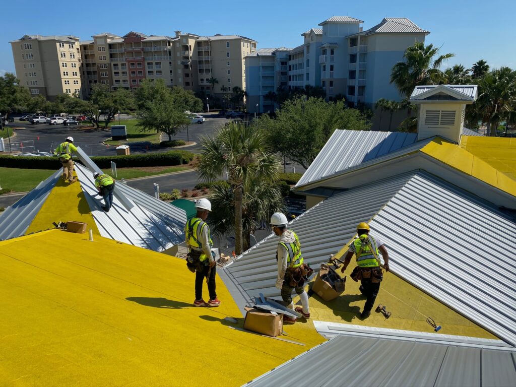 A Certified Roofing Solutions crew meticulously installing individual white standing seam metal panels over a high-performance underlayment system at Marriott Legend’s Edge.