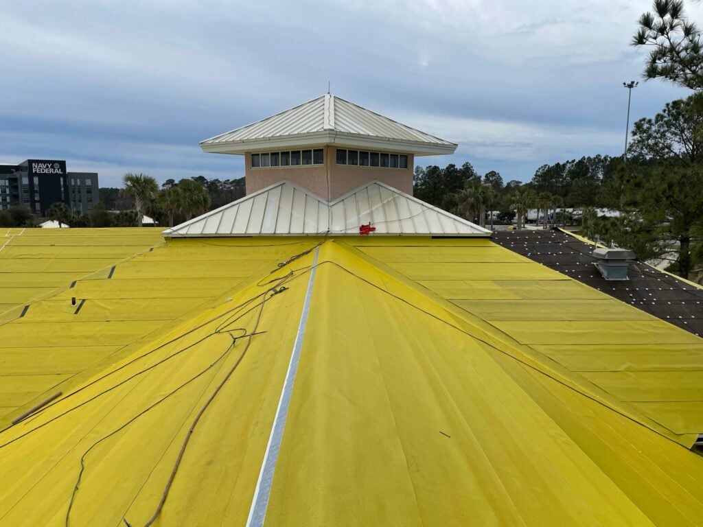 Close-up view of high-temp peel-and-stick underlayment prep work surrounding the central cupola tower on the Florida Visitor Center roof.