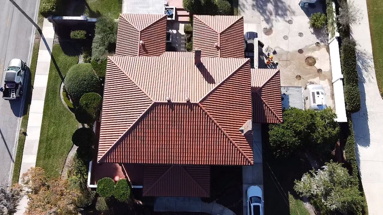 Top-down aerial view of a completed GAF Timberline HDZ shingle roof on a multi-story commercial complex in Orlando, FL.