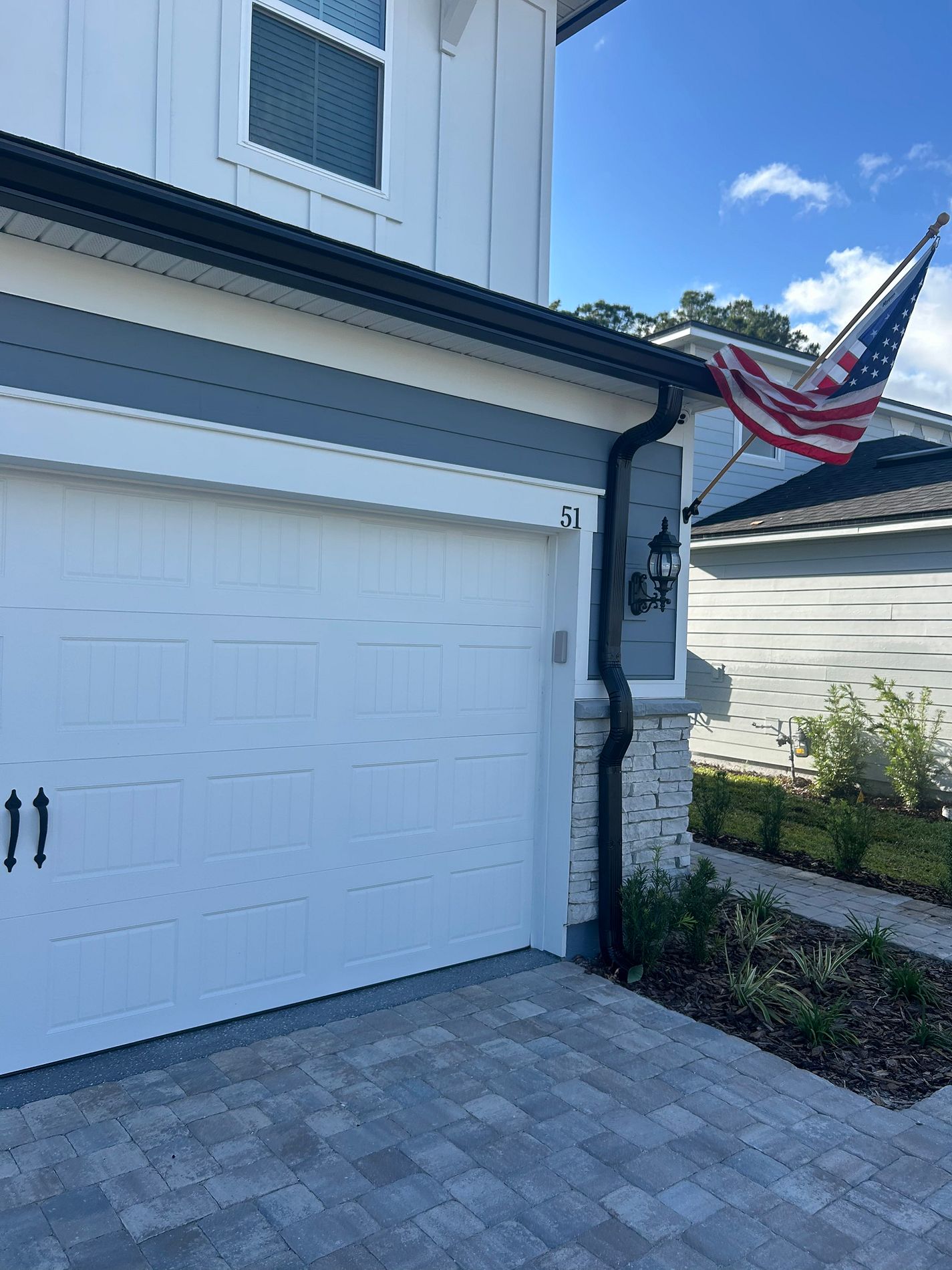 Black 6-inch K-style gutter and downspout installed on a home in St. Augustine, Florida