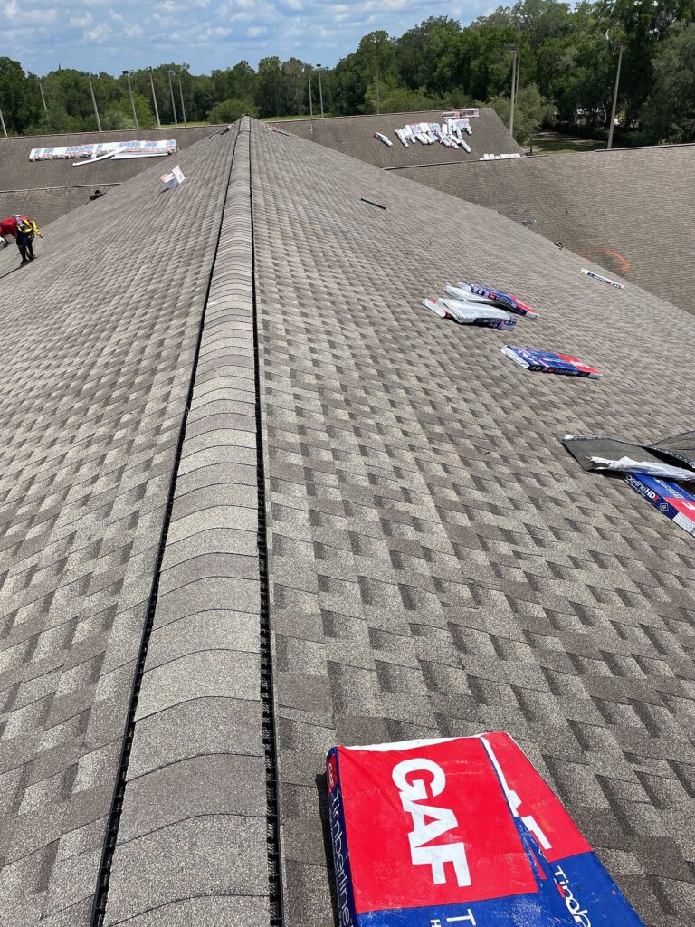 Wide corner aerial photo of a silver 24-gauge standing seam metal roof on a Sarasota commercial facility.
