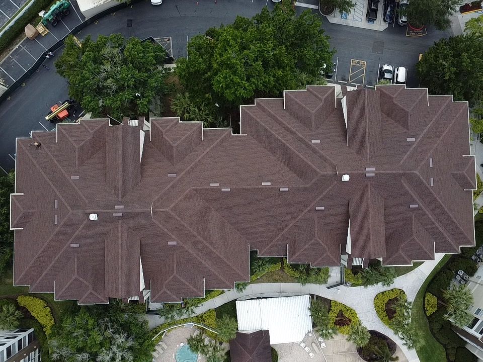 Top-down aerial view of a completed GAF Timberline HDZ shingle roof on a multi-story commercial complex in Orlando, FL.