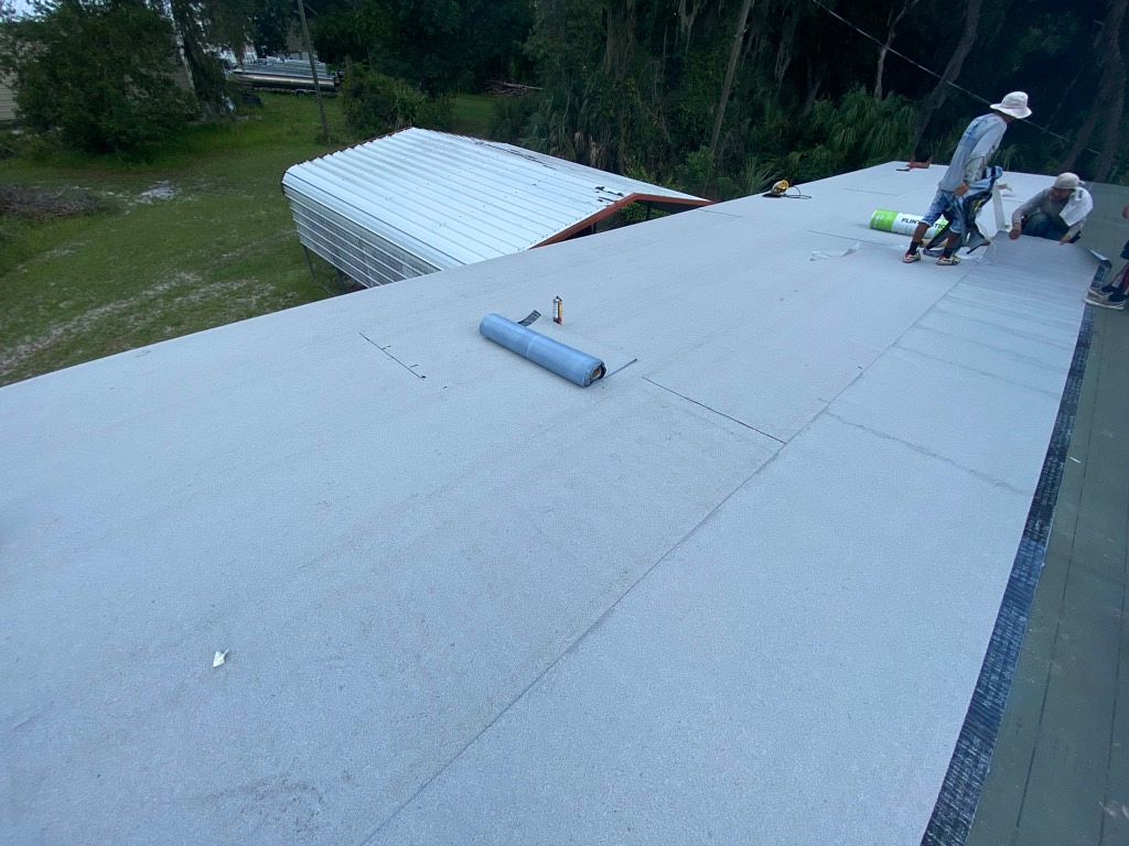 White modified bitumen roofing system installed on a property in Longwood, Florida